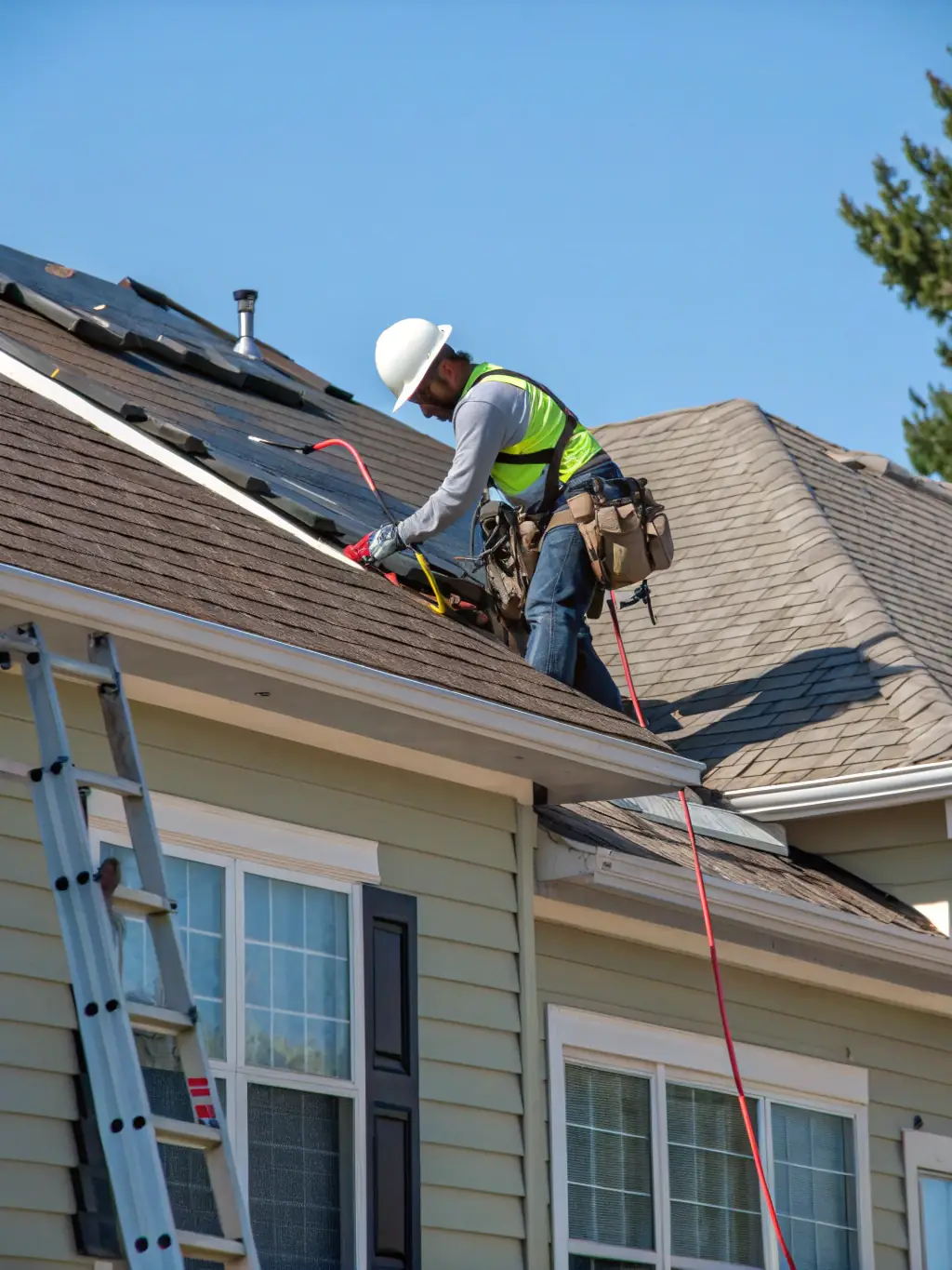A close-up shot of a Sunbright Roofing crew member installing new roofing shingles on a residential home in Orlando, Florida, under a clear blue sky, showcasing the precision and quality of their roof replacement service.